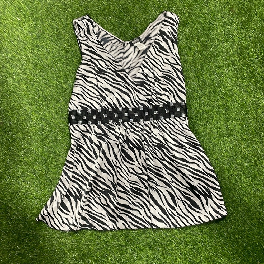 Sleeveless satin zebra striped blouse with rhinestone empire waist detail.